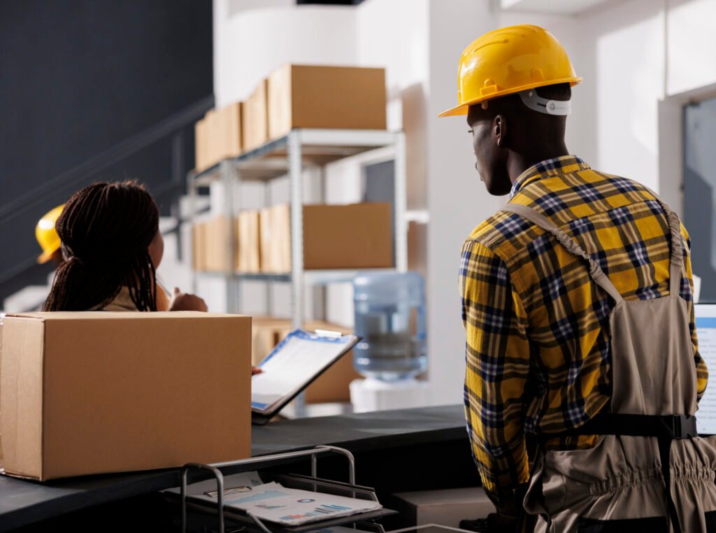 courier checking orders list, receiving parcel in retail storehouse